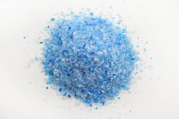 Pile of clean recycled PET flakes and granules in assorted colours